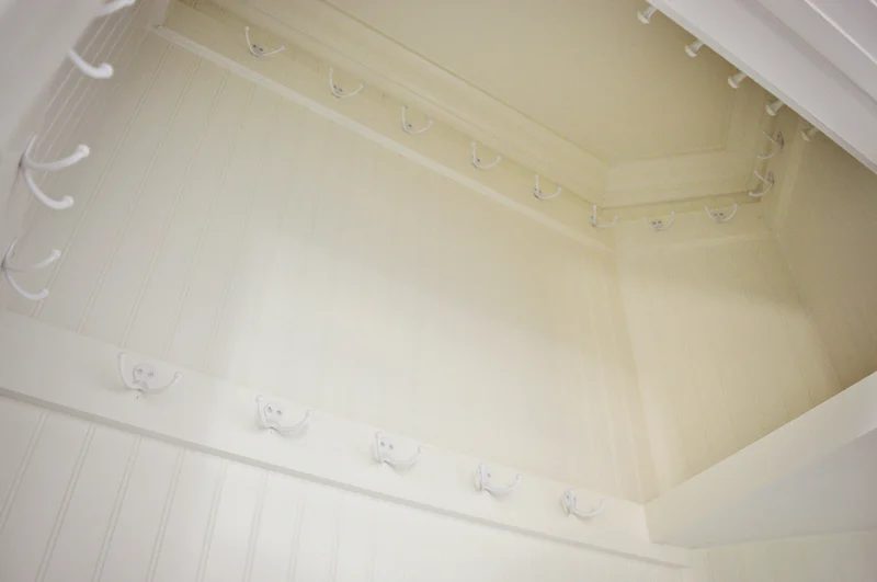 install 2 rows of hooks in a hall closet for off-season storage and double storage space