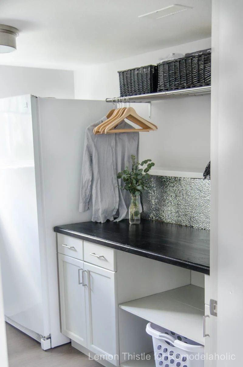 A textured metal ceiling tile backsplash is chic, modern, and durable -- and straightforward to install with a good pair of gloves and the right adhesive!