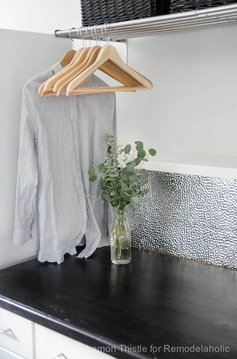 Learn how to install a unique and modern (but straightforward to clean!) metal ceiling tile backsplash. Tip #1: It's all about using the right adhesive!