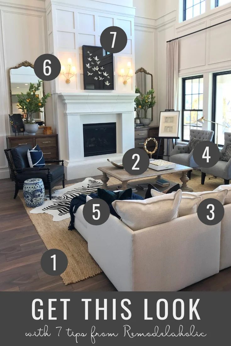 How to decorate a modern farmhouse living room with a neutral sofa and armchairs plus a striking paneled fireplace | Tips to get this look at Bekob | Home designed by Arive Homes,