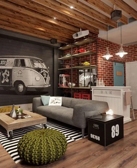 What a great space! Industrial loft style, with a brick wall and mural plus tall ceiling with beams