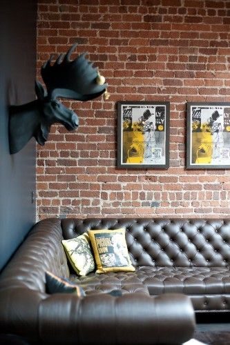 exposed brick wall + leather sofa. Need this!