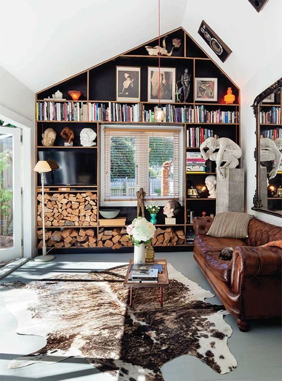 Love the leather sofa and the black and gold bookcases