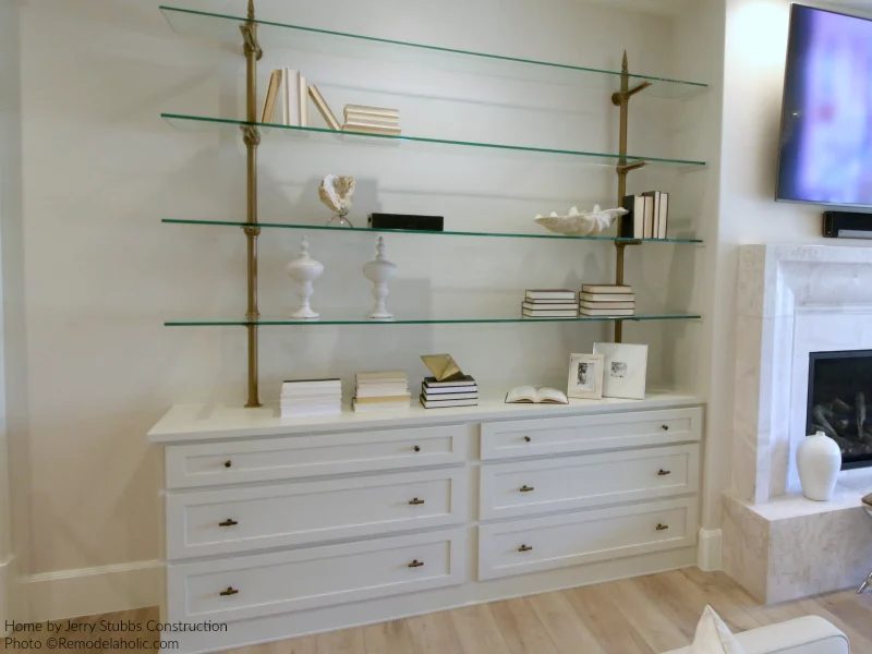 White Decor On Open Glass Shelving Adds Lightness In This Basement Family Room Jerry Stubbs And Tique And Co 2018 Utah Valley Parade Of Homes Featured On Bekob