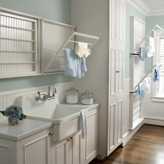 striking Laundry Room With Fold Out Drying Racks