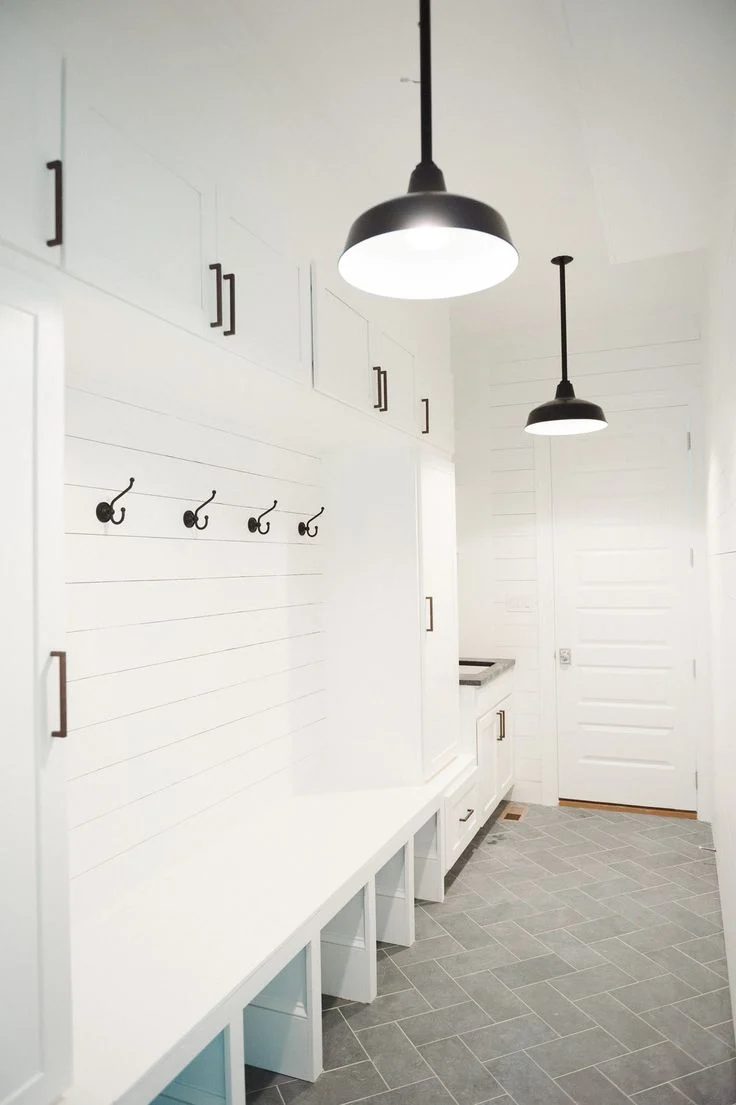 This black and white mudroom is striking! Love the gray tile floor.