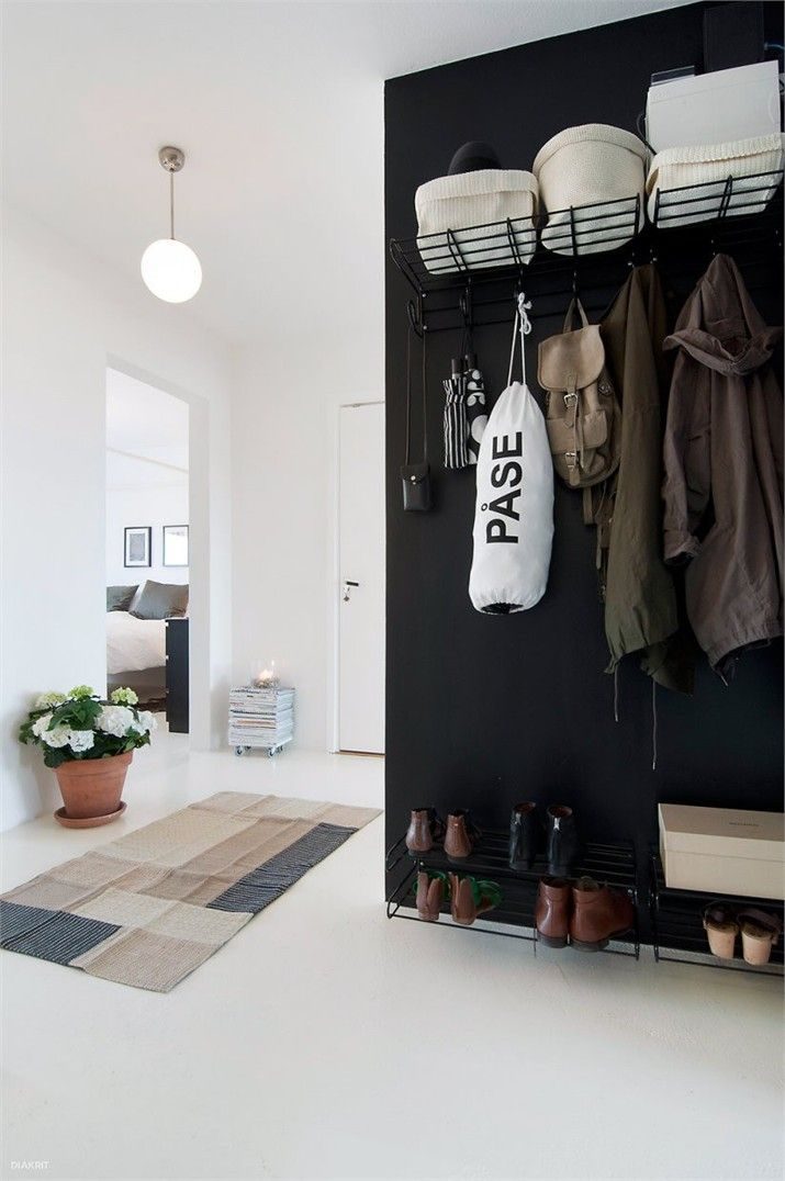 Monochrome Entry Inspiration: I like the black accent wall at the entry, it helps hide the black shelves rather than putting them on display.