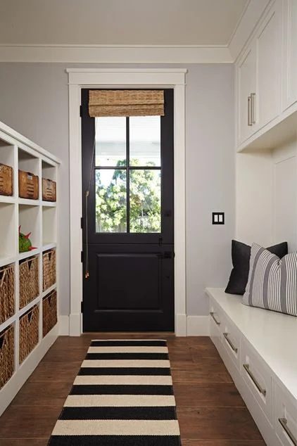 vivid monochrome entryway. Plenty of storage with those cube shelves and the drawers in the bench. I need that striped rug!