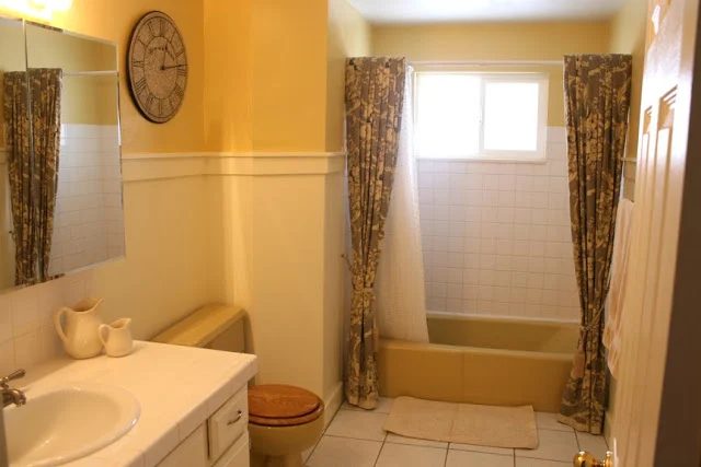 Yellow tub and toilet updated yellow and grey bathroom