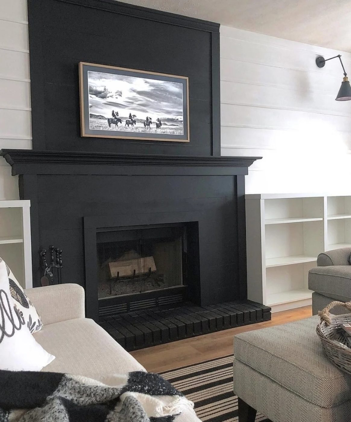 Black Fireplace With White Planked Walls And Built In Shelves