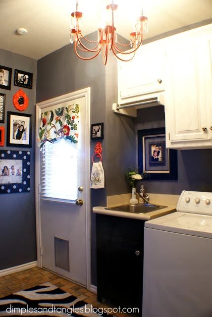 redecorated laundry room with organization and chandelier