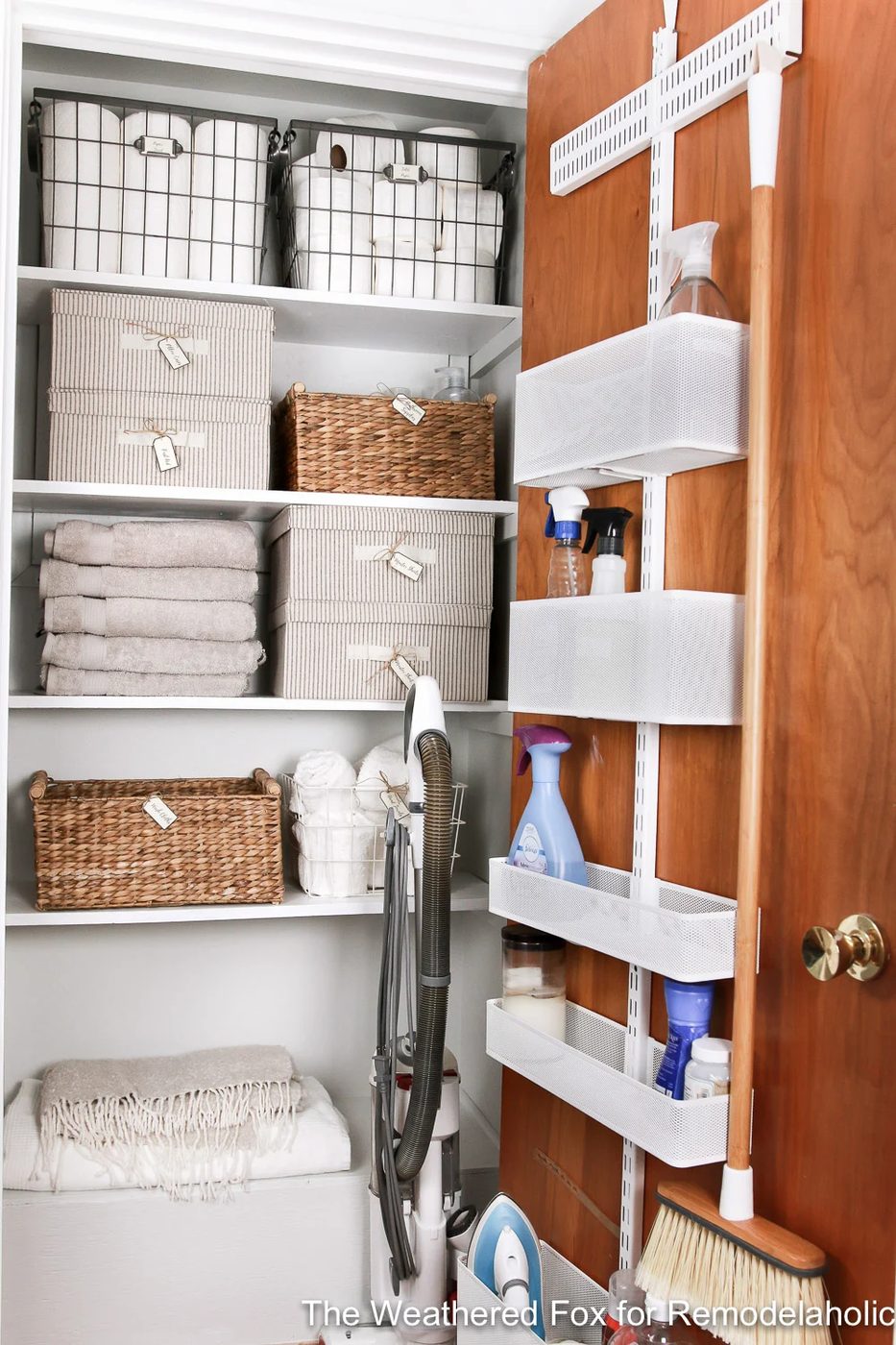 Get organized! This linen closet makeover features an adjustable over the door organizer for cleaning supplies, plus baskets and boxes to organize AND there's room to store the vac