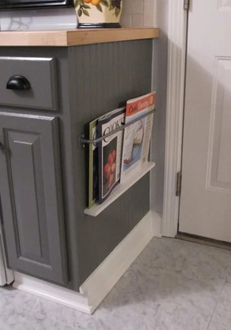 small space saving rack on the side of the cabinet, for cookbooks or magazines White Tulip Designs