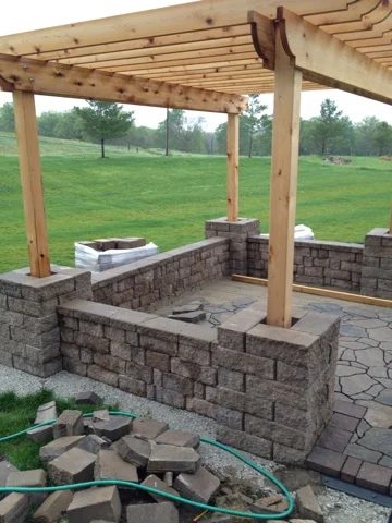 build a patio with a pergola and seat wall