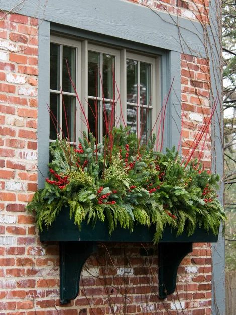 winter holiday greenery in window boxes, Mariani Landscape via Traditional Home