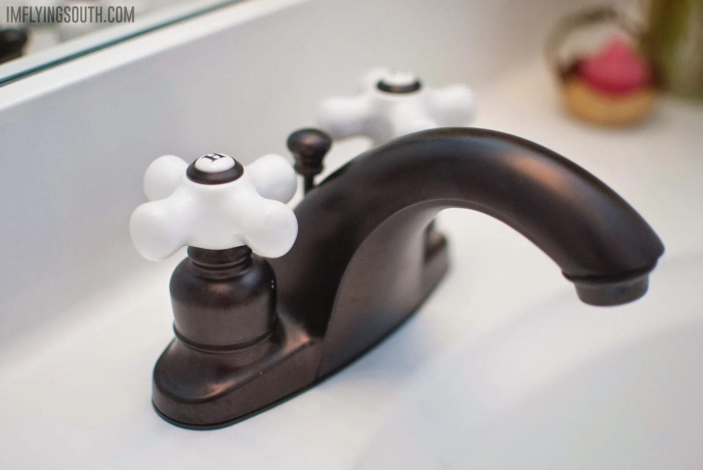new bathroom faucet on a painted bathroom countertop sink - I'm Flying South featured on @Bekob