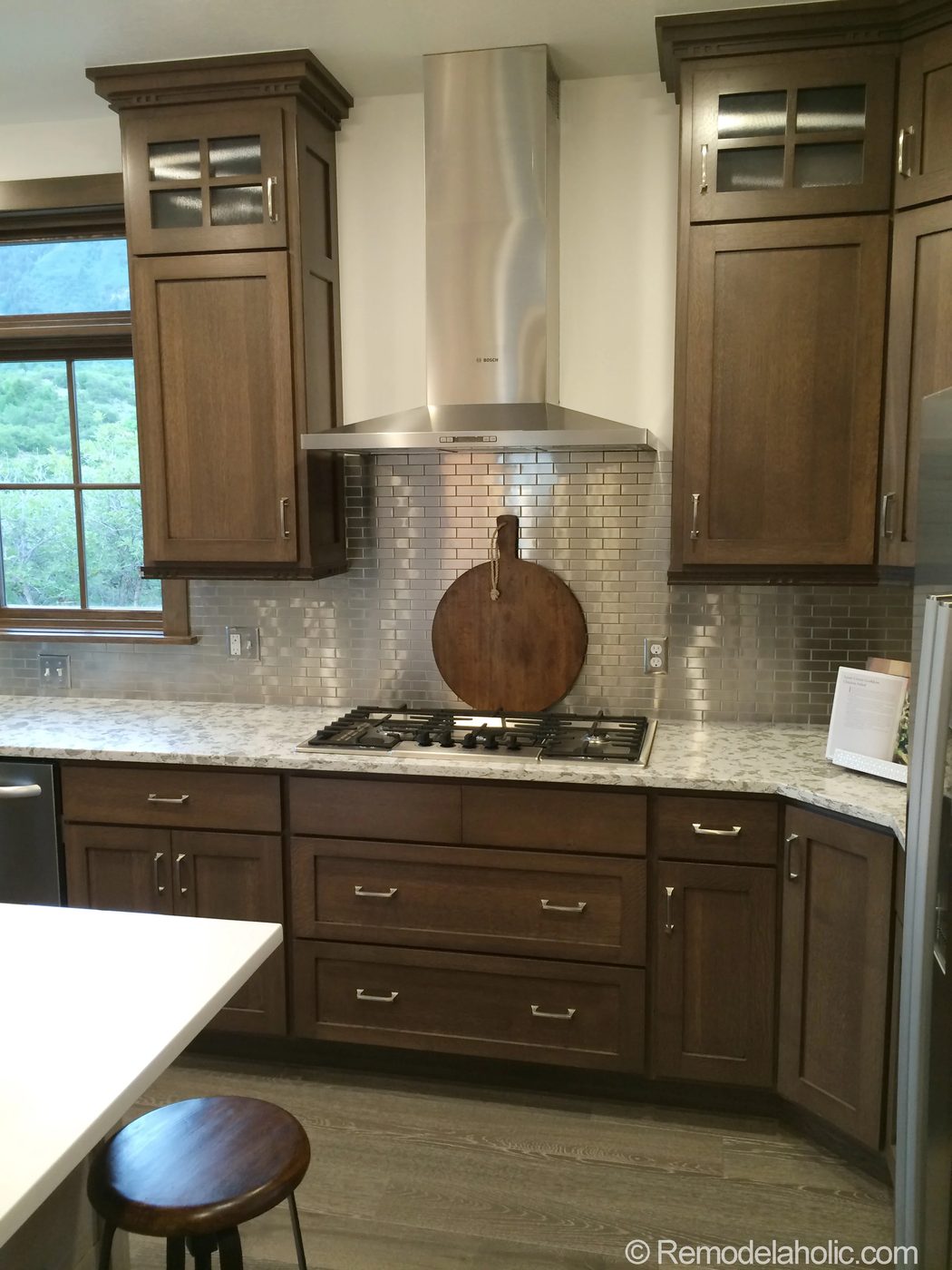 Walnut kitchen with Stainless steel tile backsplash
