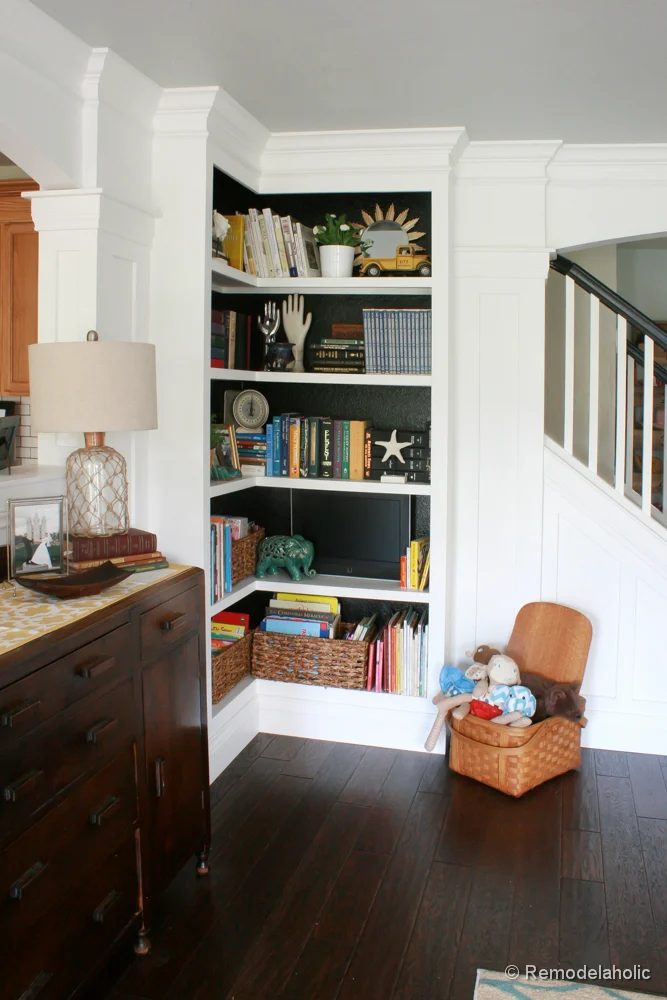Living Room Remodel with yellow accents wood floors and built-in bookcases and columns with arches-23