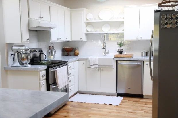 white kitchen makeover with marble tile countertops and subway tile backsplash