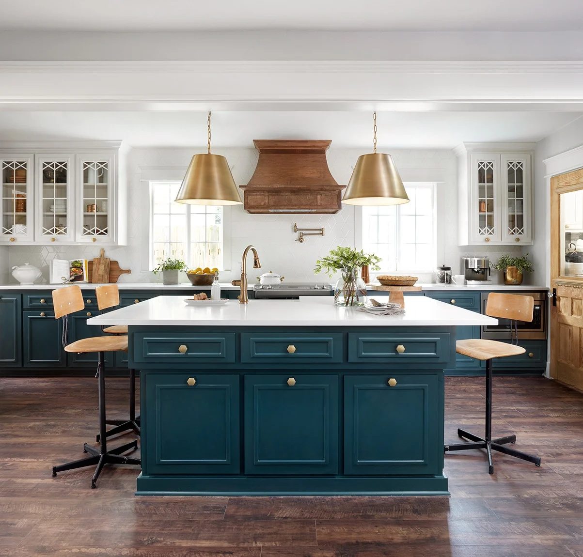 Fixer Upper Plain Jane House Kitchen. Love the white cabinets with the peacock blue island and gold pendants.
