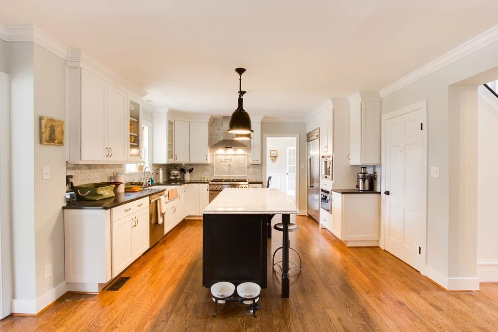 white kitchen renovation with marble island and open shelving on Bekob