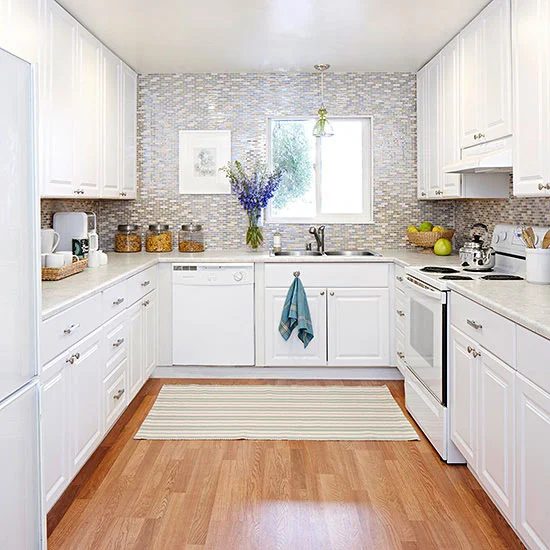U shaped kitchen floor plan with white cabinets and full tile backsplash wall via BHG
