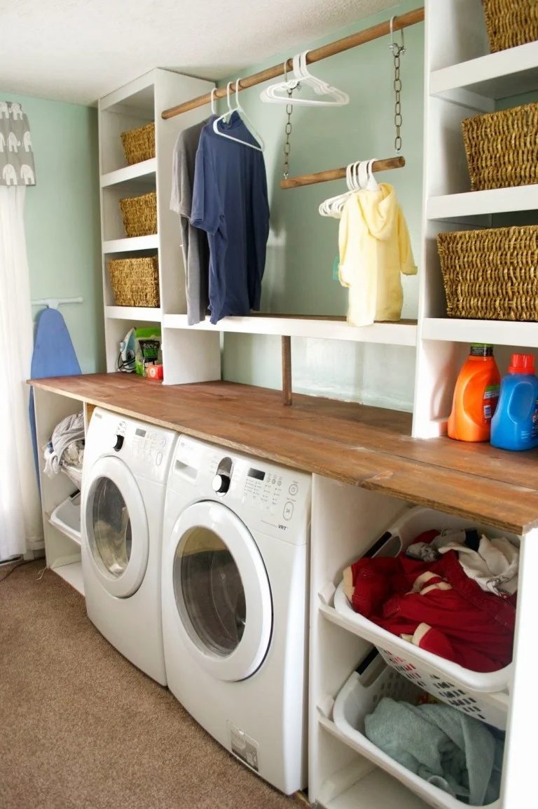 White Front Load Washer And Dryer With Stained Wood And Painted White Shelving And Clothes Rod