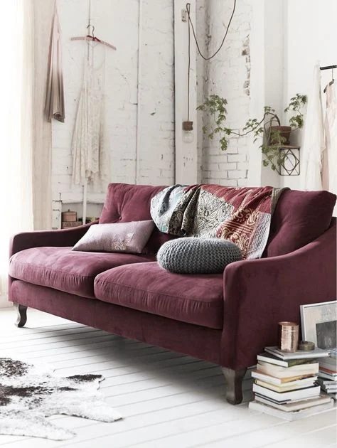 Decorating a neutral living room, with a maroon couch