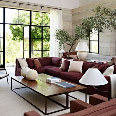 Decorating a neutral living room, with a maroon couch
