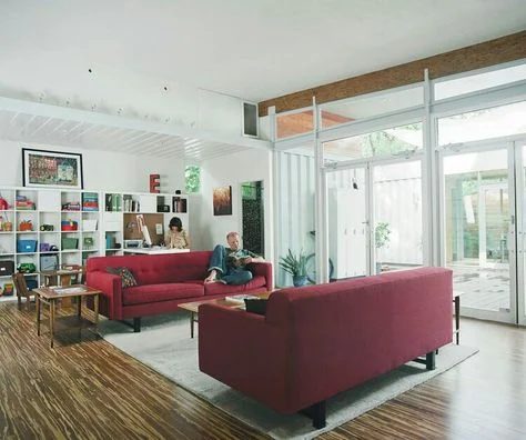 Decorating a neutral living room, with a maroon couch