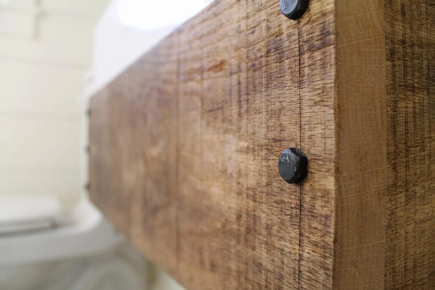 lag bolts for an industrial style floating reclaimed wood vanity - Girl Meets Carpenter featured on @Bekob