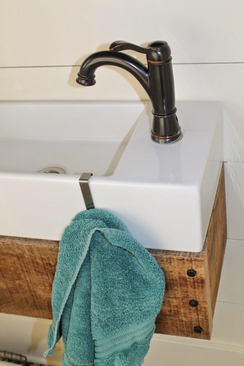towel holder on IKEA sink with handmade floating vanity - Girl Meets Carpenter featured on @Bekob
