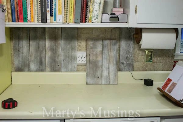 use primer to adjust the color of reclaimed wood for kitchen backsplash