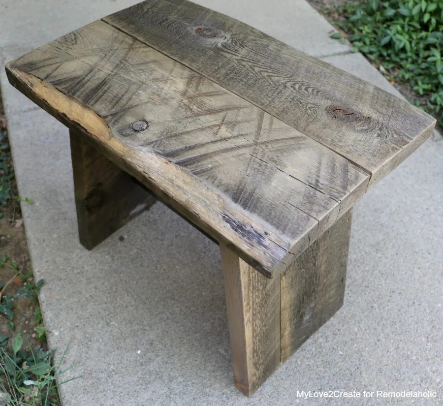 A wooden stool made of reclaimed wood.
