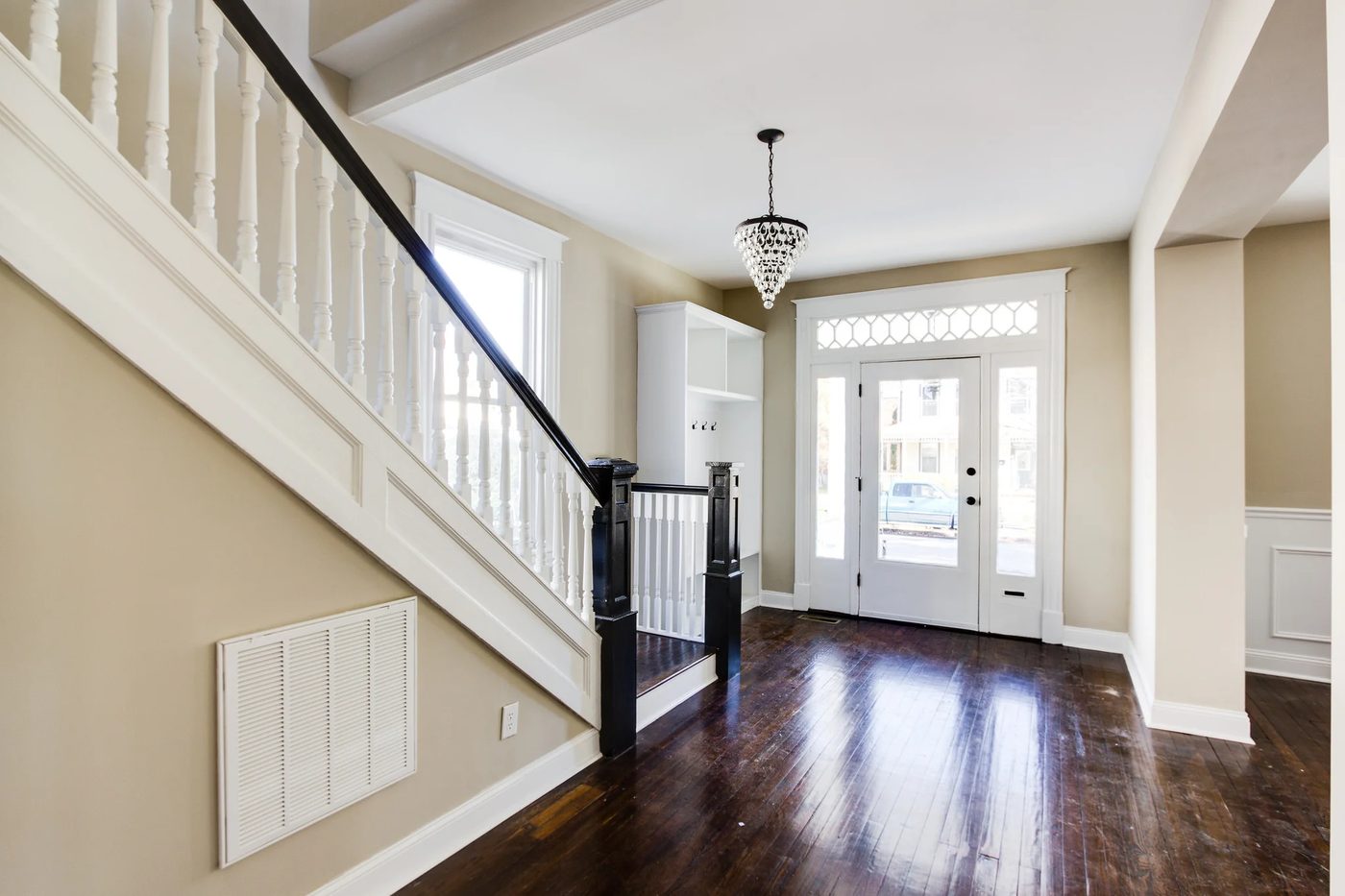 Inviting entryway with dark walnut floors and built-in storage (Griffin) @Bekob
