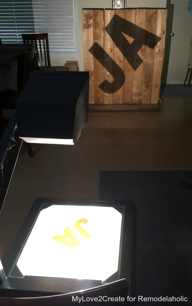overhead projector to transfer letters on pallet wood for memorable rustic industrial letters