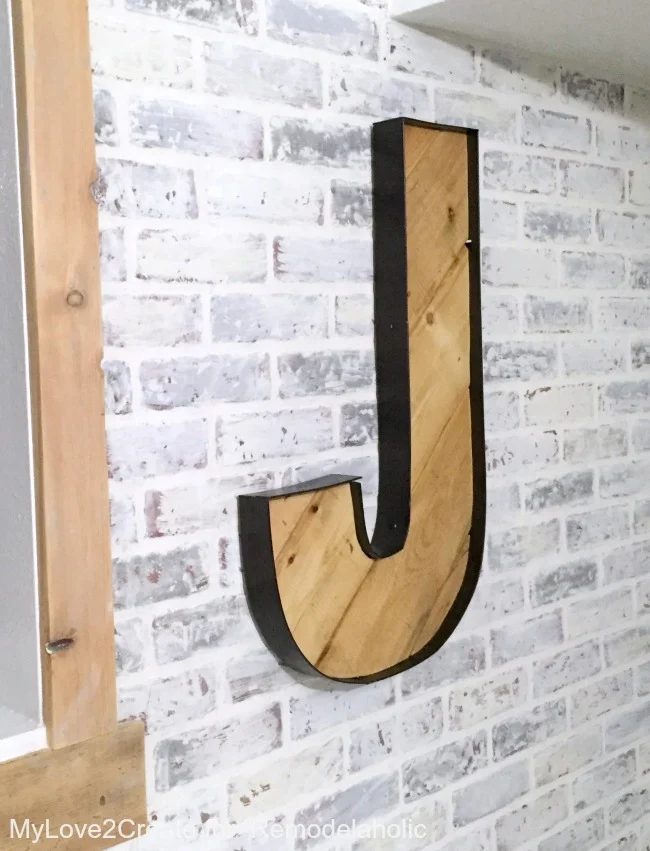 The rustic industrial wood and faux metal on these Handmade letters looks well fitted with the whitewashed faux brick wall. So great for a teen room!