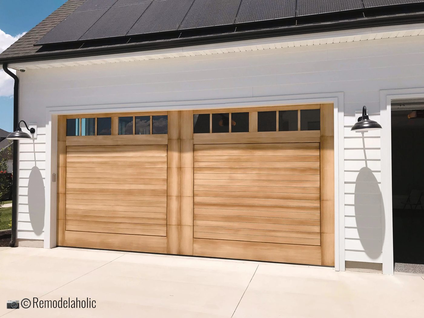 Outdoor farmhouse lighting around a garage, UVPH 2018 Home 17 Millhaven Homes, Four Chairs Furniture & Design, Photo by Bekob