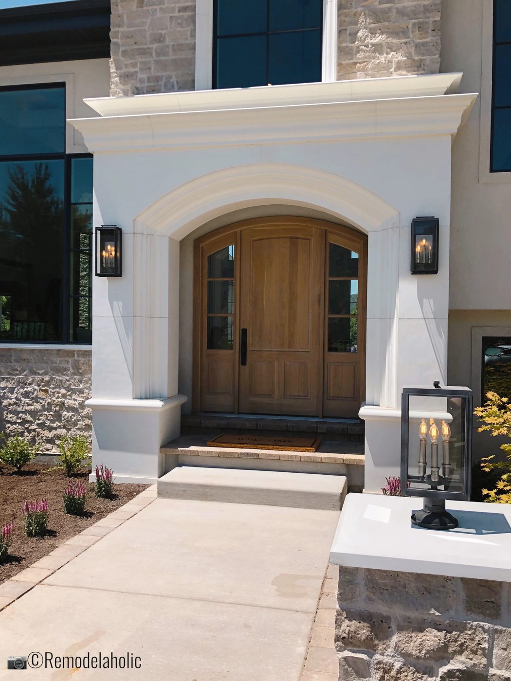 Adding unique outdoor lighting for curb appeal, UVPH 2018 Home 31 Raykon Construction, White + Gold Design, Photo by Bekob