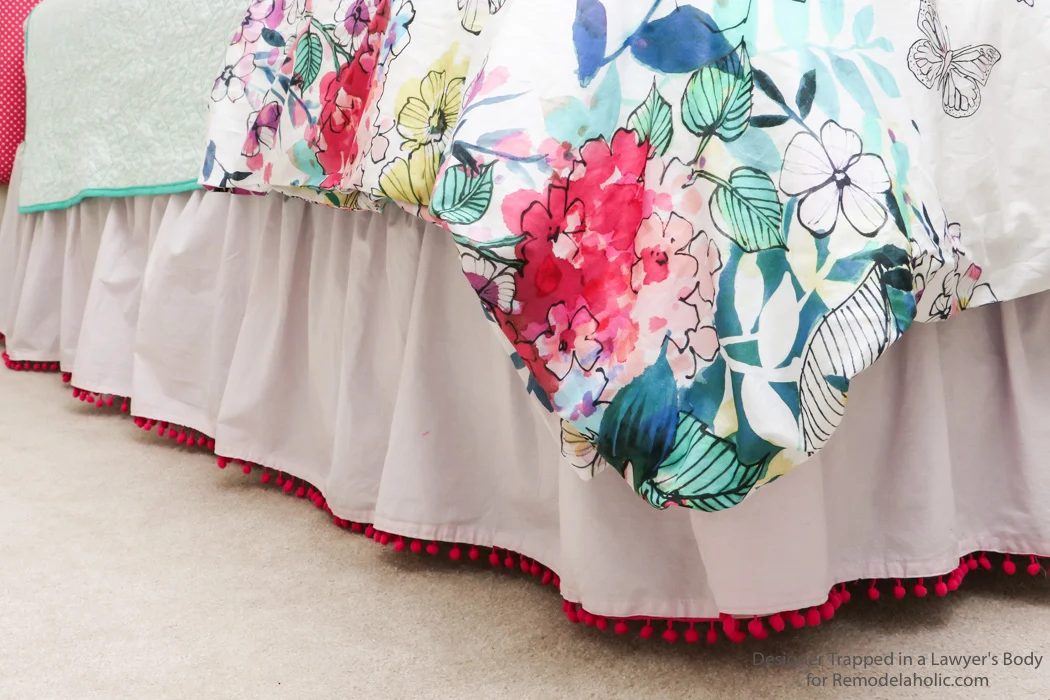 Embellished bed skirts are expensive! If you are on a modest-cost, create this semi-homemade pom pom bedskirt without breaking the bank. It's a high-end look on a modest-cost!