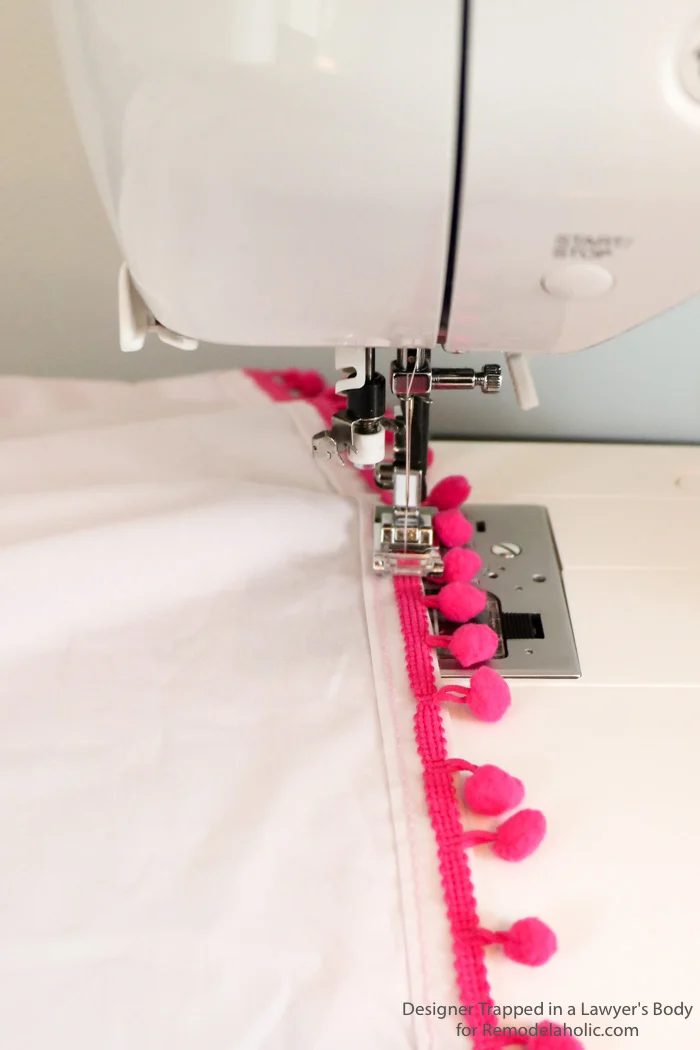 Embellished bed skirts are expensive! If you are on a modest-cost, create this semi-homemade pom pom bedskirt without breaking the bank. It's a high-end look on a modest-cost!