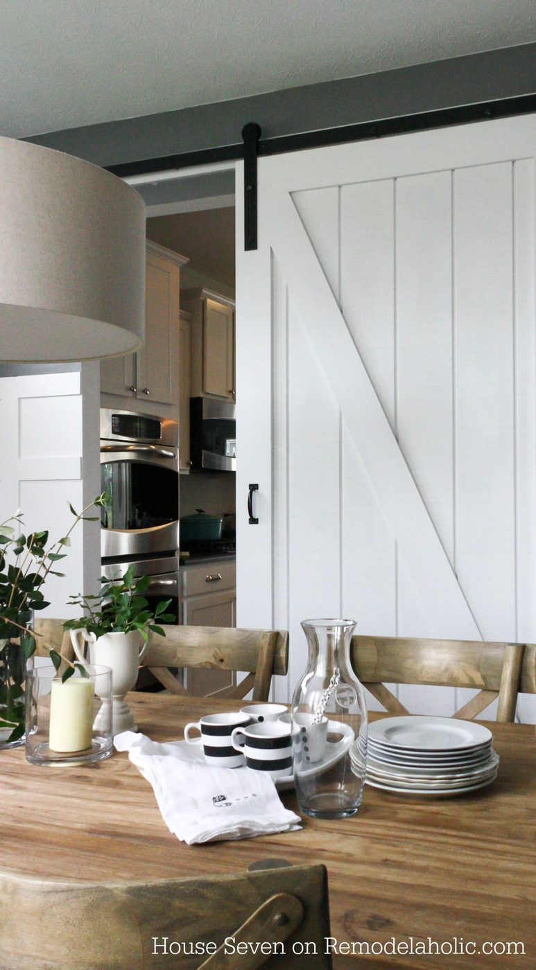 Build a striking sliding barn door with great detail using siding! Free plans and walkthrough on @Bekob