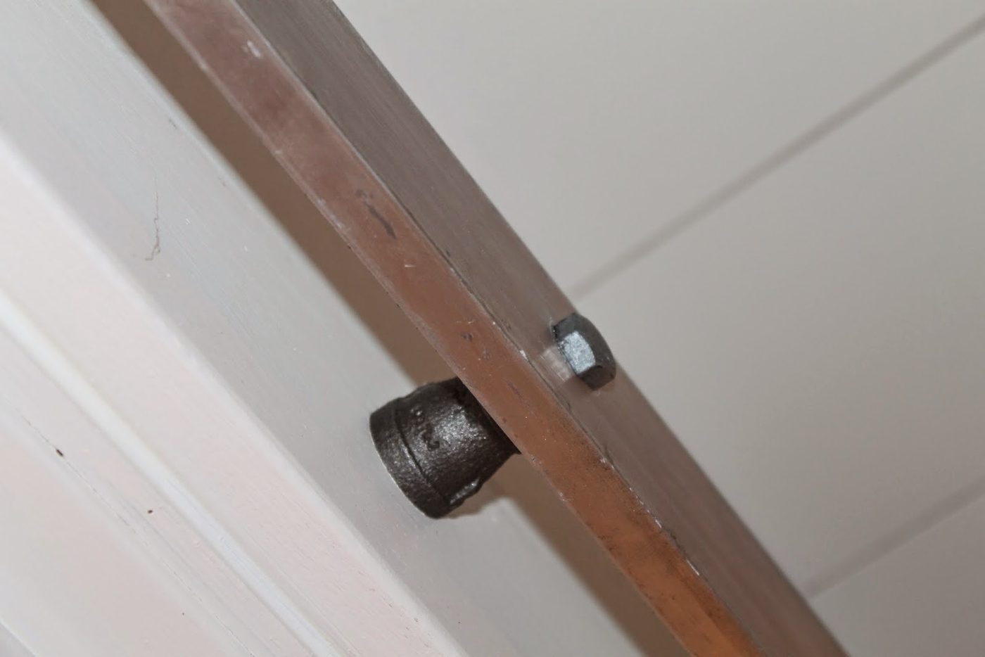 use pipe fittings to space a sliding barn door rail off the wall, Girl Meets Carpenter on @Bekob