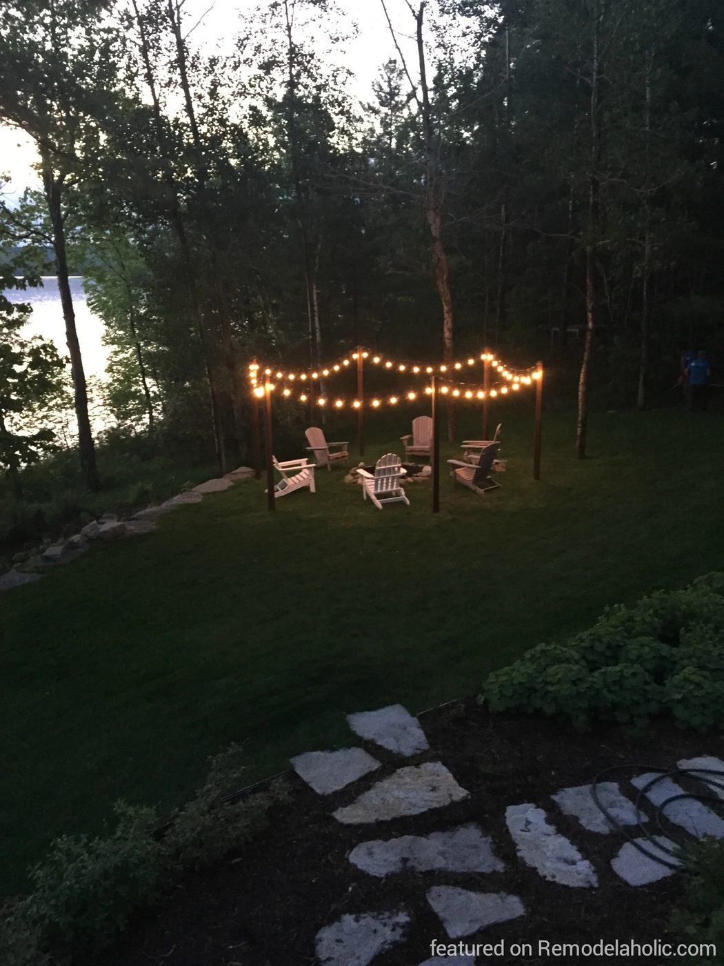 Handmade outdoor lighting posts for string lights around a fire pit, featured on @Bekob wm