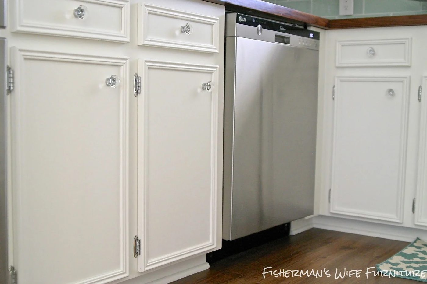 glass knobs and molding on white kitchen cabinets with vinyl plank flooring, Fisherman's Wife Furniture featured on Bekob.com