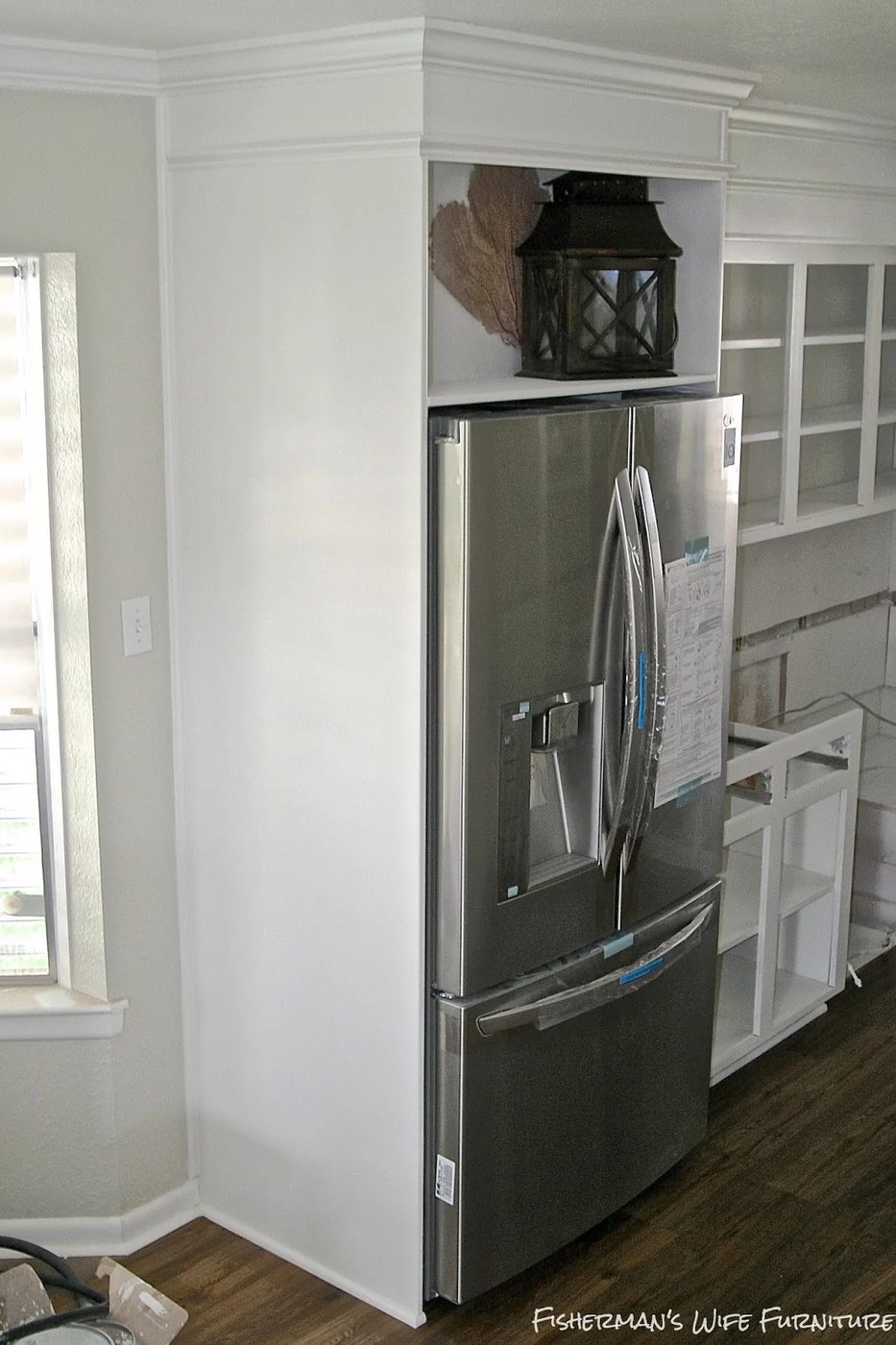 built-in fridge enclosure in a small white kitchen, Fisherman's Wife Furniture featured on Bekob.com