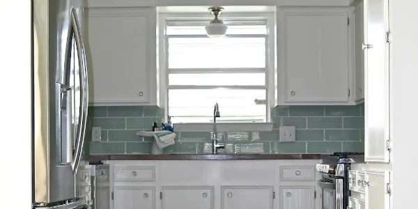 Small White Kitchen Makeover with Built-In Fridge Enclosure