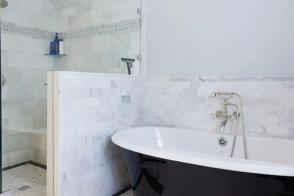 (Coventry) white marble walk-in shower with black and white standalone tub and marble surround @Bekob