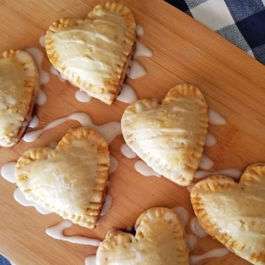 striking Individual Heart Shaped Blackberry Pies, Mini Pies, With Frosing Drizzled On Top