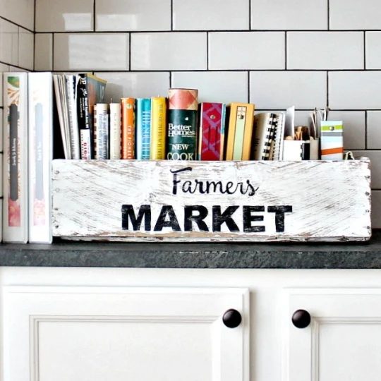 Wooden Basket Painted White With Farmers Market On The Side And Filled With Cook Books
